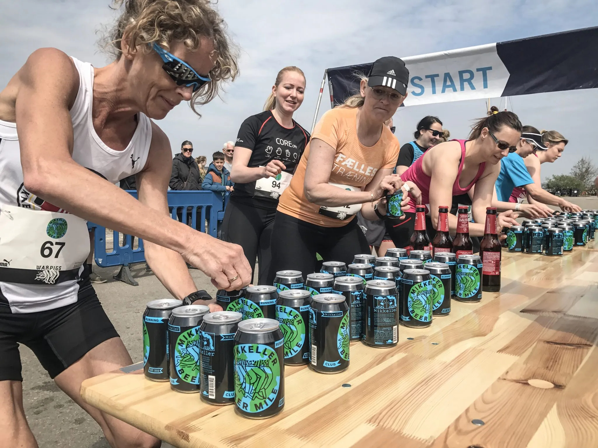 Runners drinking beer at start of race