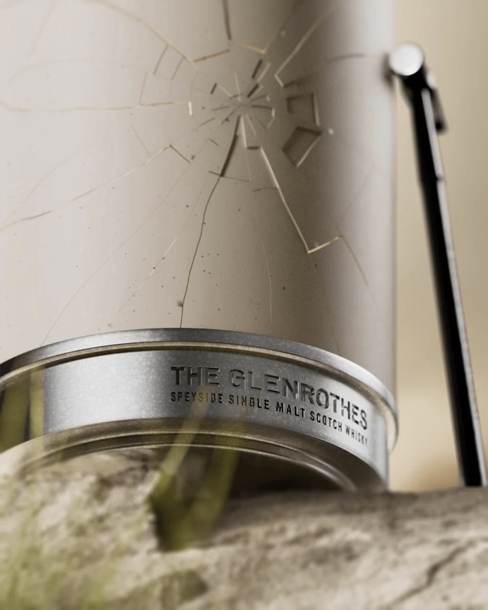 A porcelein cylinder with a nameplate at its base, with a cracked surface and a small hammer leaning against it.