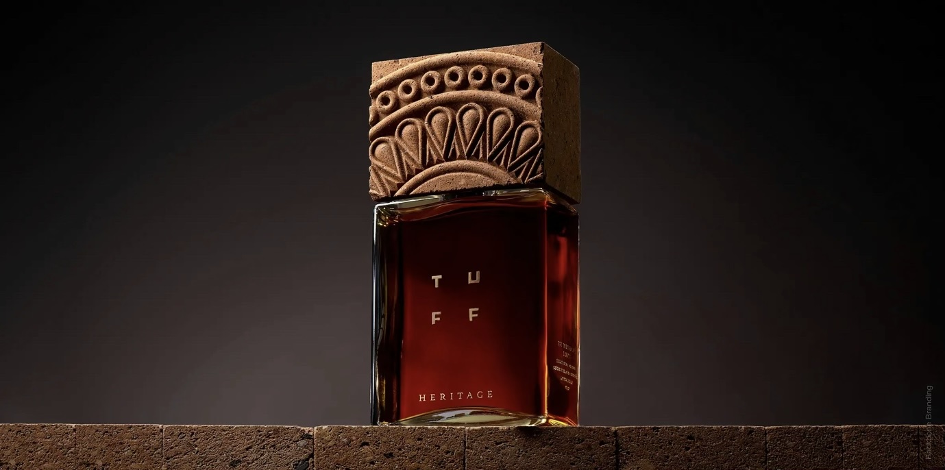 Bottle of Tuff brand brandy with a large cap made of volcanic rock and distinguished by an intrictate carved design.
